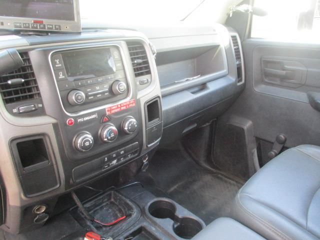 The interior of a dodge ram truck with a monitor on the dashboard.