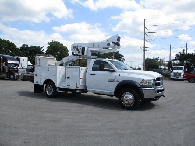 A white utility truck is parked in a parking lot