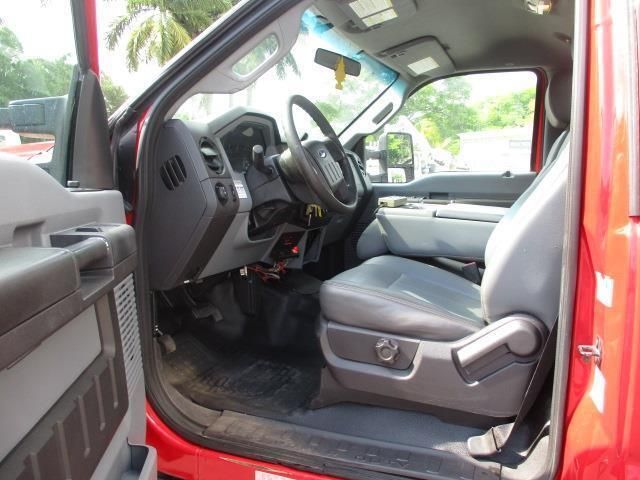 The inside of a red truck with the door open