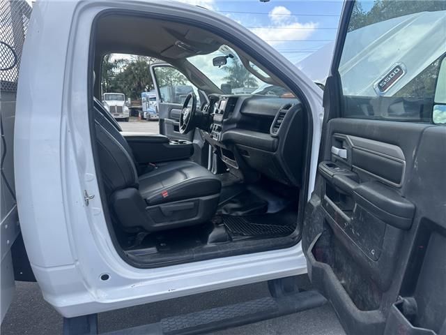 The inside of a white truck with the door open.