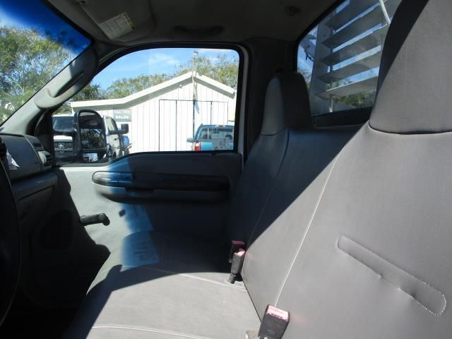 The back seat of a truck with a gray seat cover