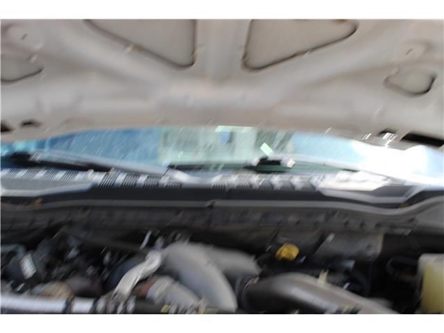 A close up of a car engine with the hood up