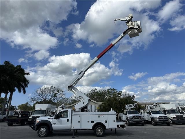A white utility truck with a bucket on top of it