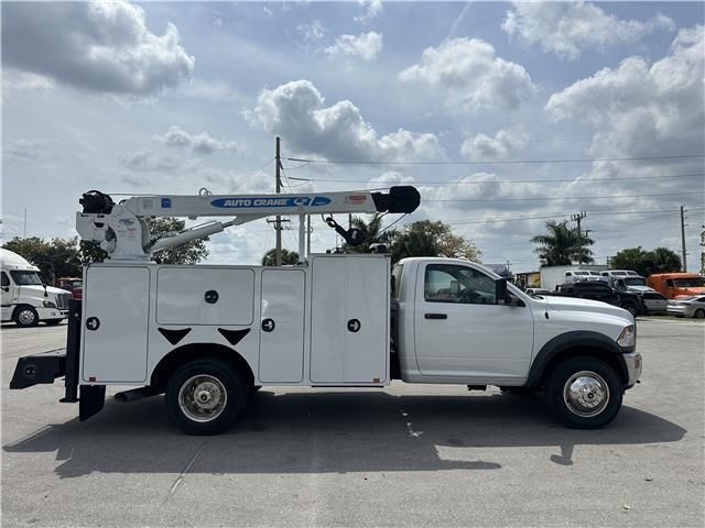 A white utility truck is parked in a parking lot