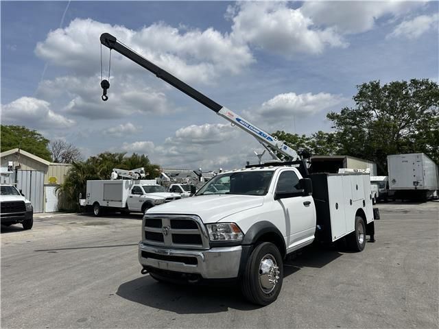 A white utility truck with a crane attached to it