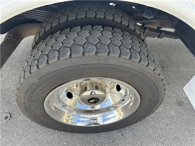 A close up of a truck tire with a chrome rim