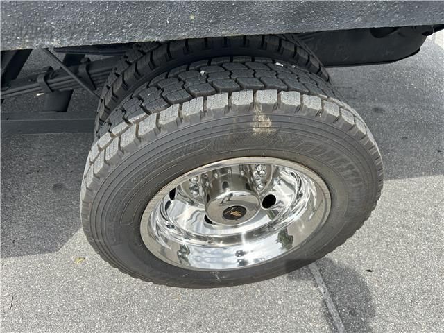 A close up of a truck tire with a chrome rim