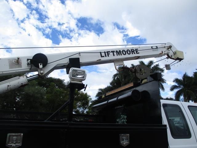 A lift moore truck with a crane attached to it