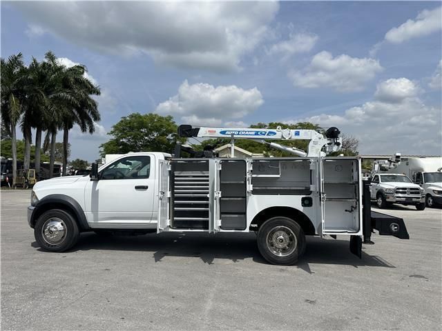 A white utility truck is parked in a parking lot