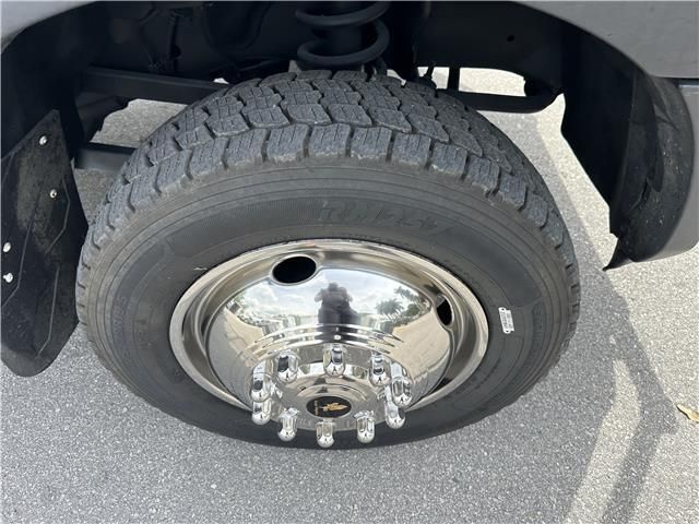 A close up of a tire on a truck with a chrome rim