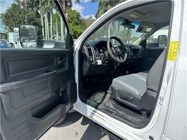 The inside of a white dodge ram truck with the door open.