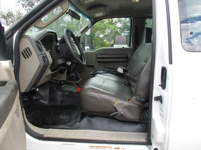 The inside of a white truck with the door open