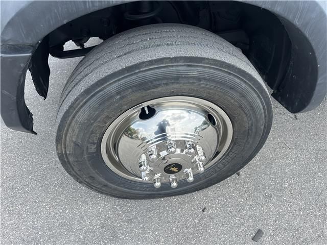 A close up of a tire on a truck with a chrome rim.