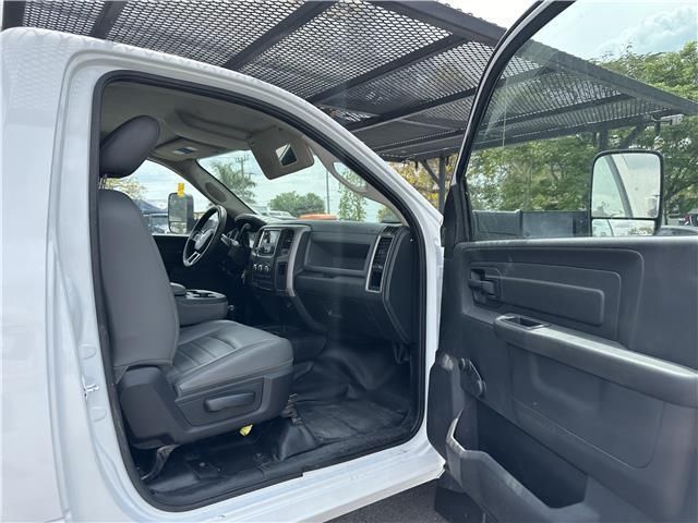 The inside of a white truck with the door open.