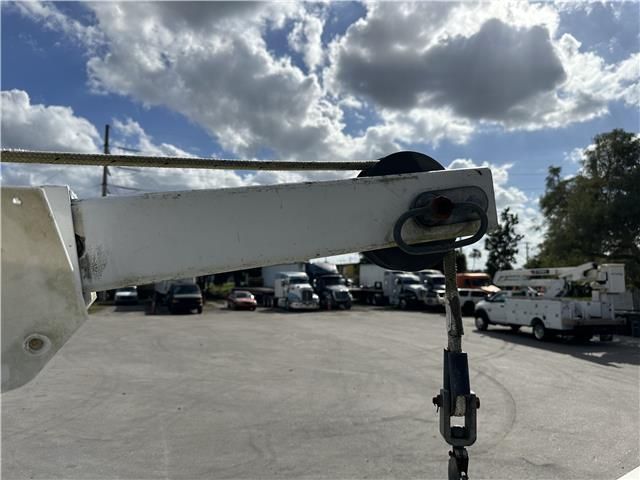 A white truck is parked in a parking lot