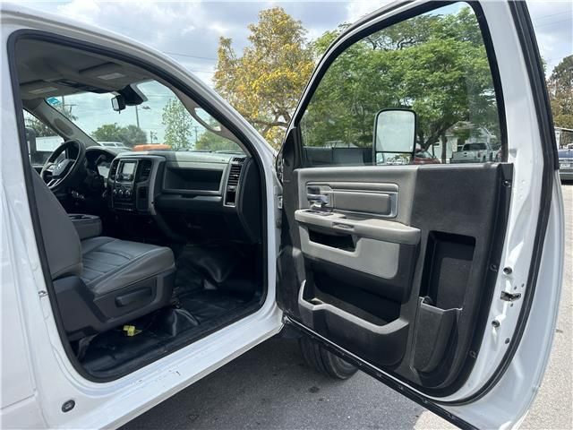 The inside of a white dodge ram truck with its doors open.