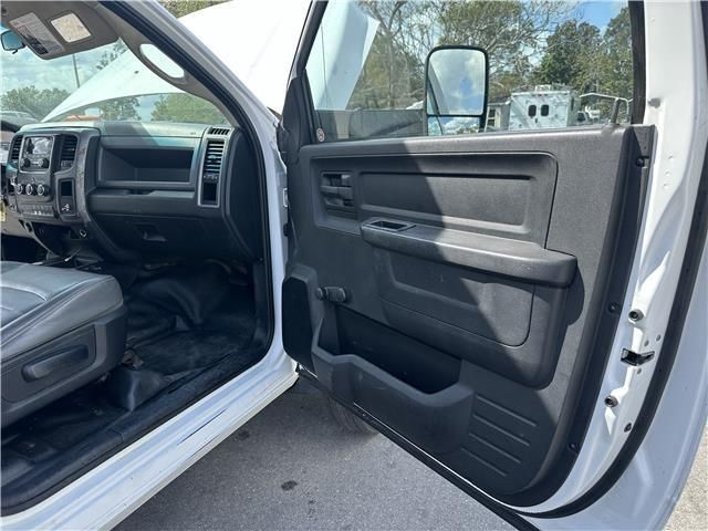 The inside of a white truck with the door open