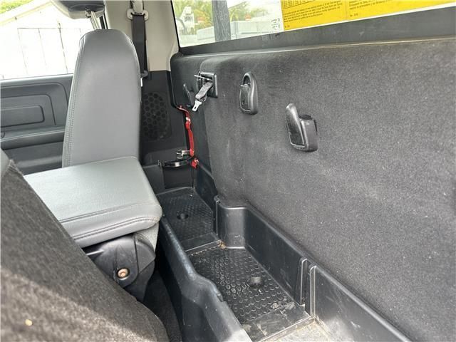 A close up of the back seat of a truck with a seat belt.