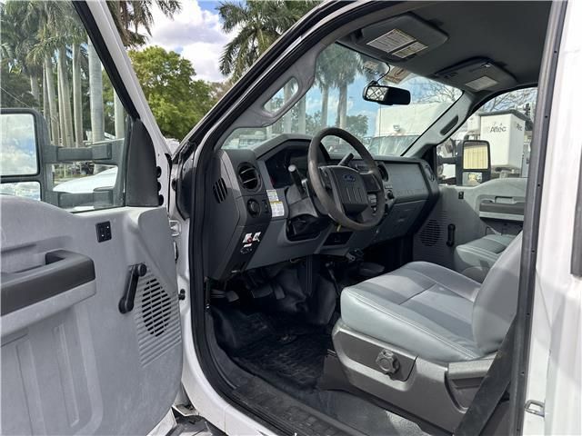 The inside of a white truck with the door open