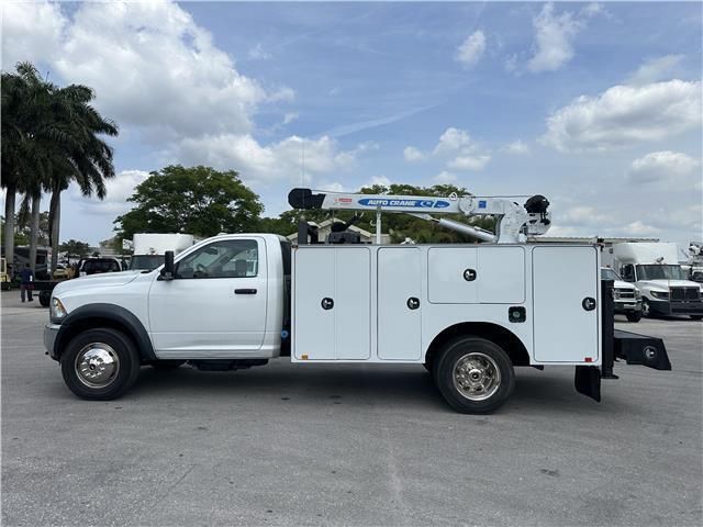 A white utility truck is parked in a parking lot.