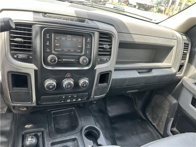 The interior of a dodge ram truck with a radio on the dashboard.