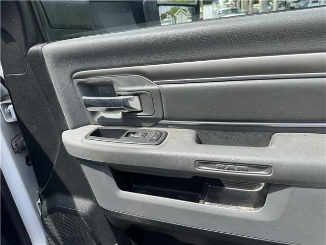A close up of a door handle on a white dodge ram truck.