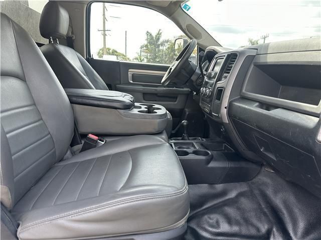 The interior of a dodge ram truck with black leather seats
