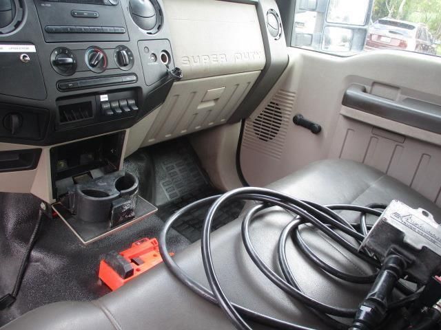The interior of a ford truck with a bunch of wires laying on the seat