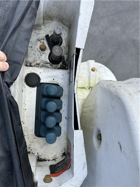 A person is holding a black cloth over a white object