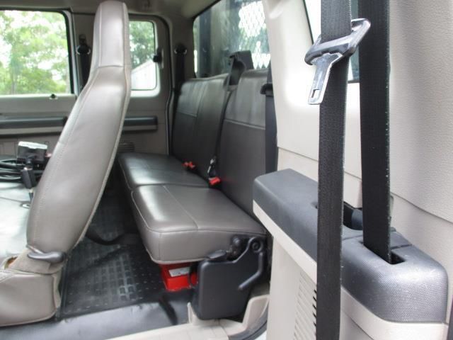 The back seat of a truck has a seat belt on it