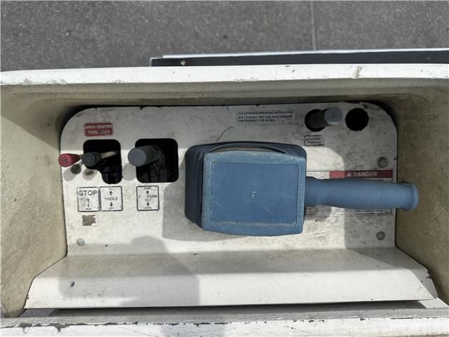 A white box with a blue handle and buttons on it