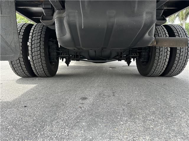 A close up of the underside of a truck on a road.
