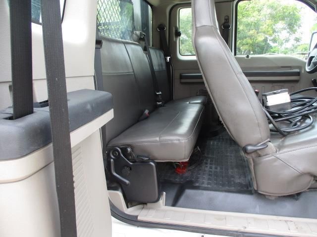 The back seat of a white truck with a gray seat