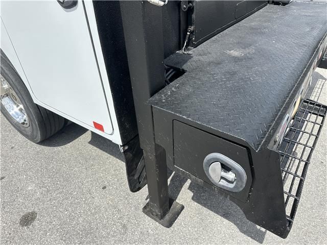 A white truck with a black box on the side of it.