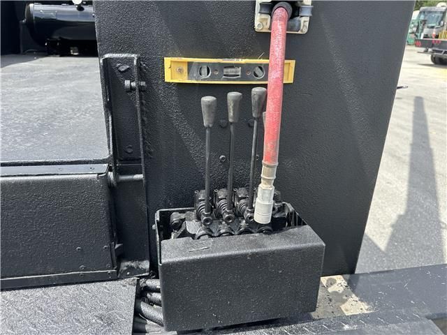 A black box with a red hose attached to it