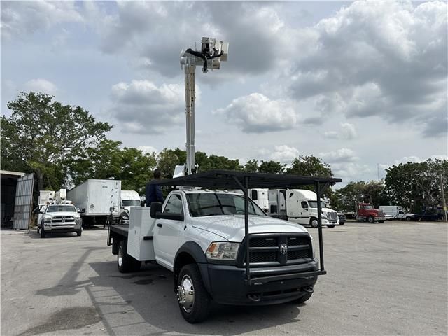 A white truck with a ladder on top of it is parked in a parking lot