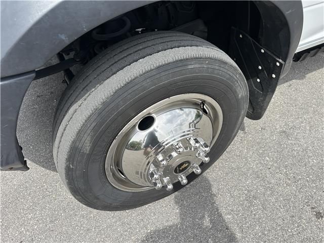 A close up of a truck tire with a chrome rim