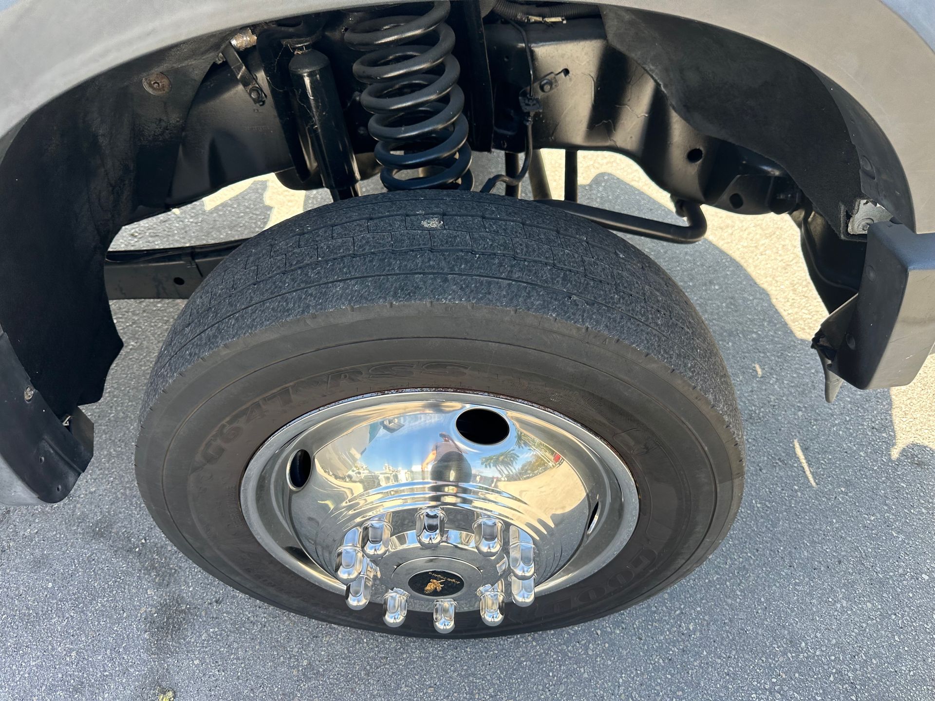 A close up of a tire on a truck with a chrome rim.