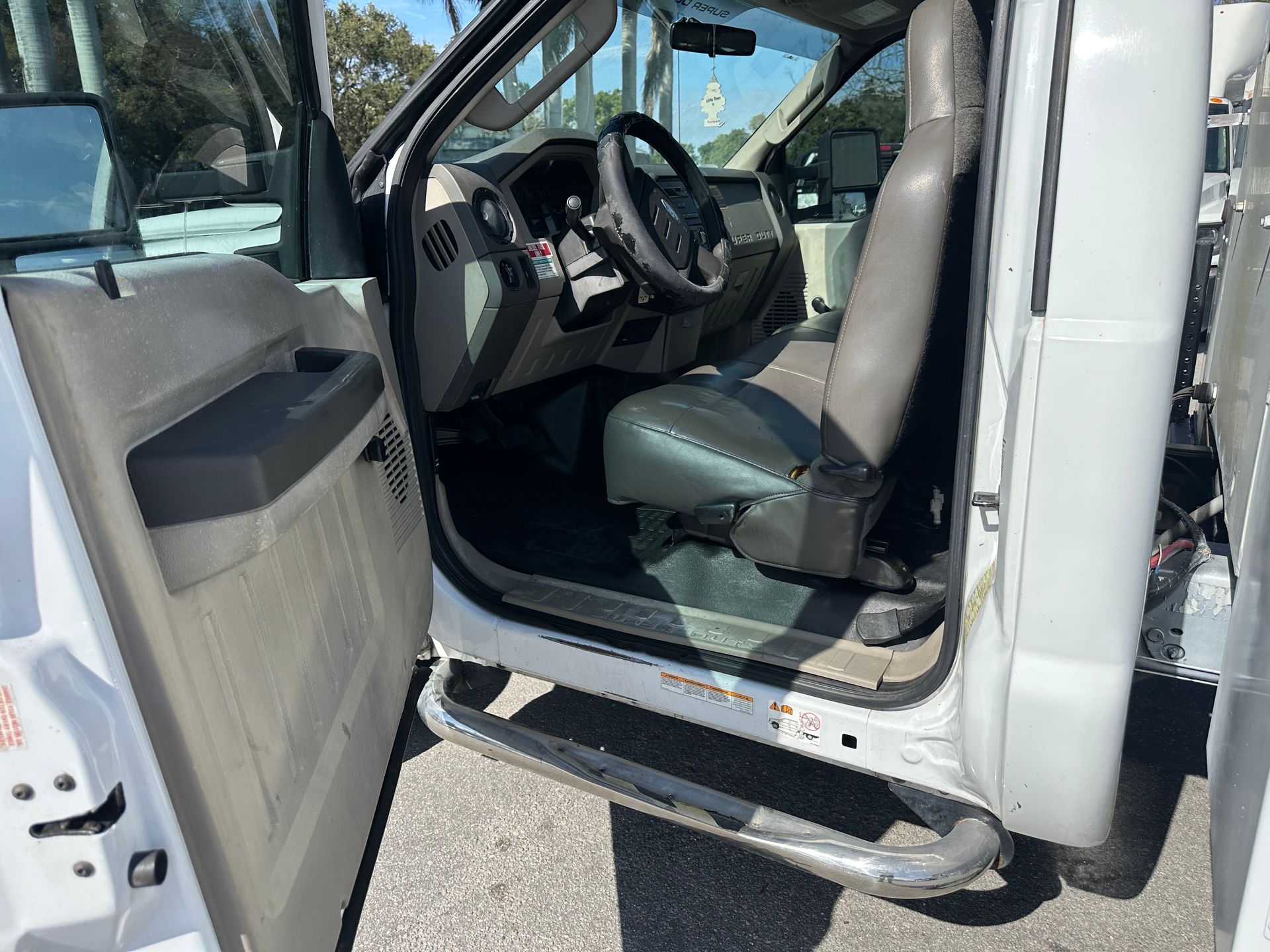 The inside of a white truck with the door open.