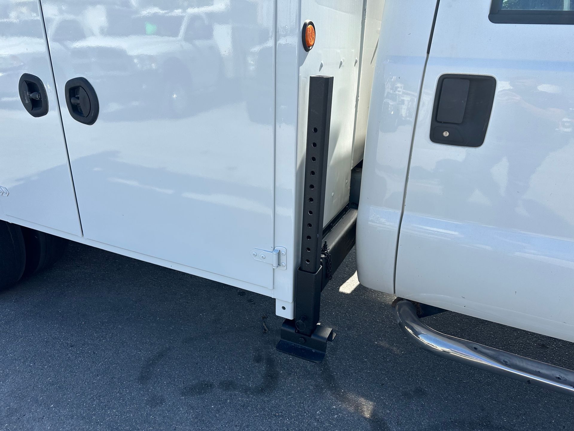 A white truck is parked on the side of the road.