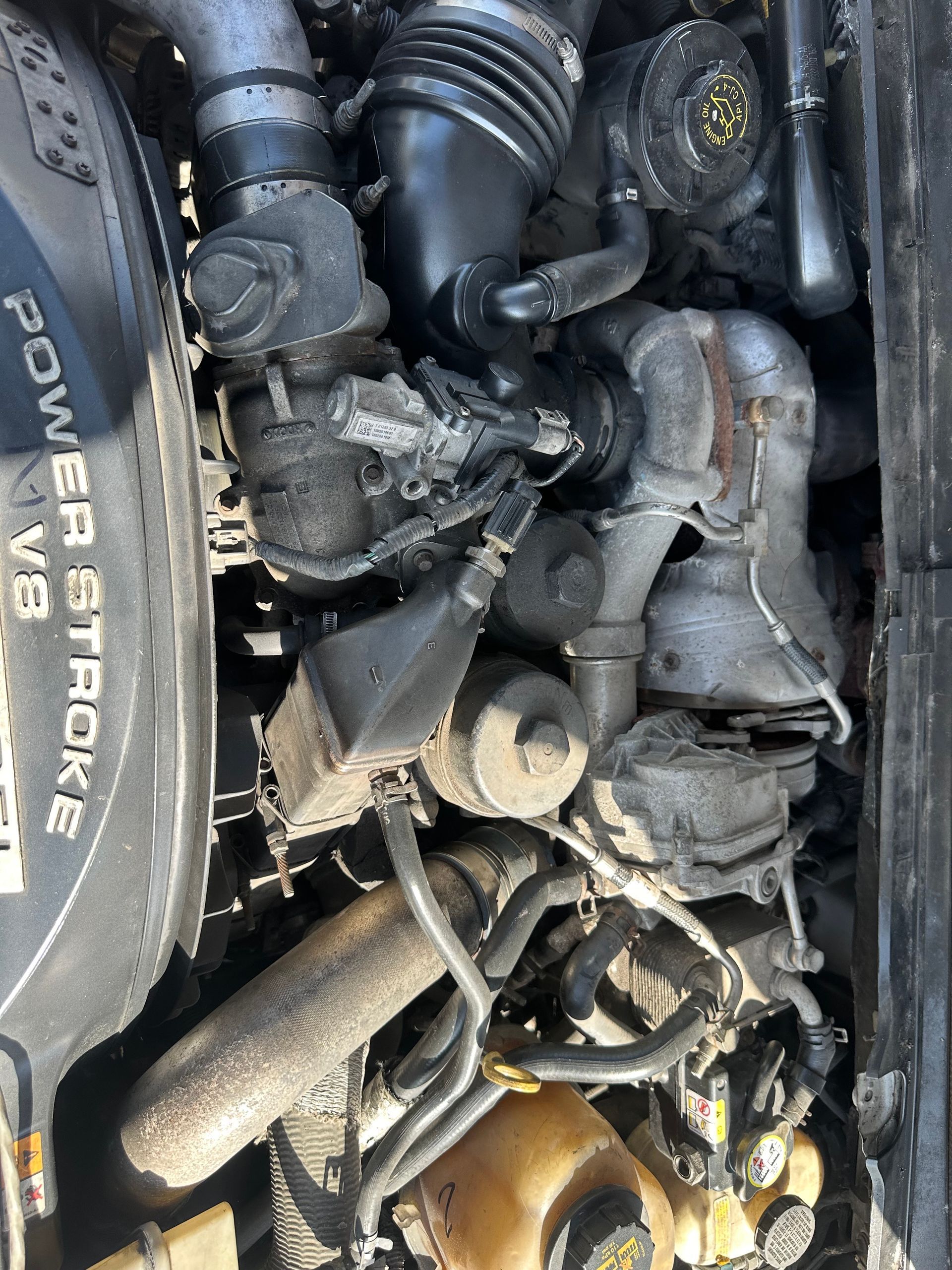 A close up of the engine of a car with a power stroke v8 engine.