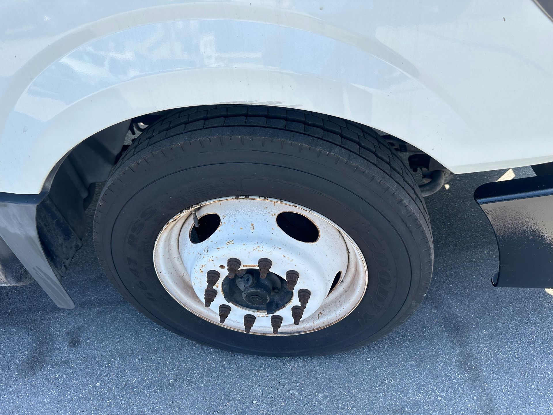 A close up of a tire on a white truck.
