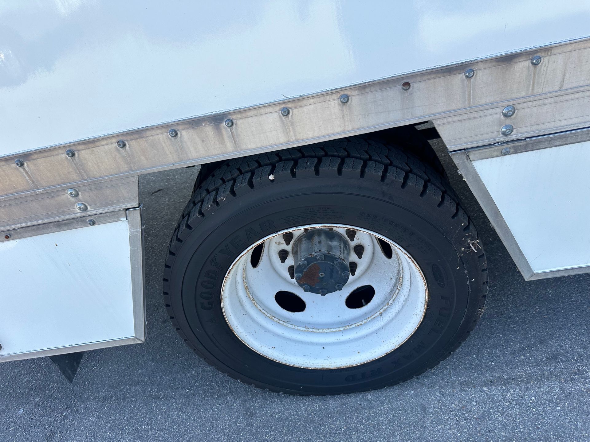 A close up of a tire on a white truck.
