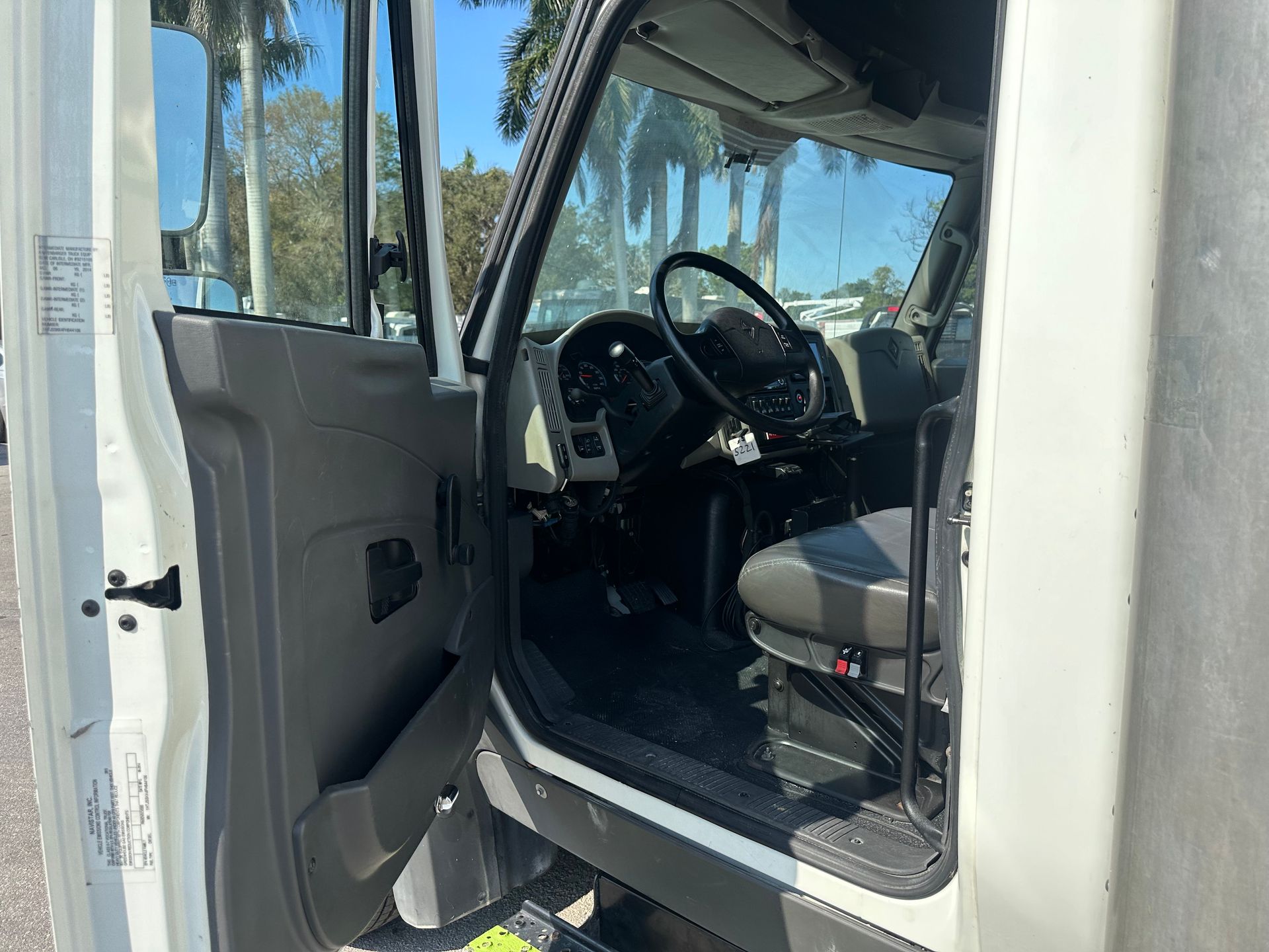 The inside of a white truck with the door open.