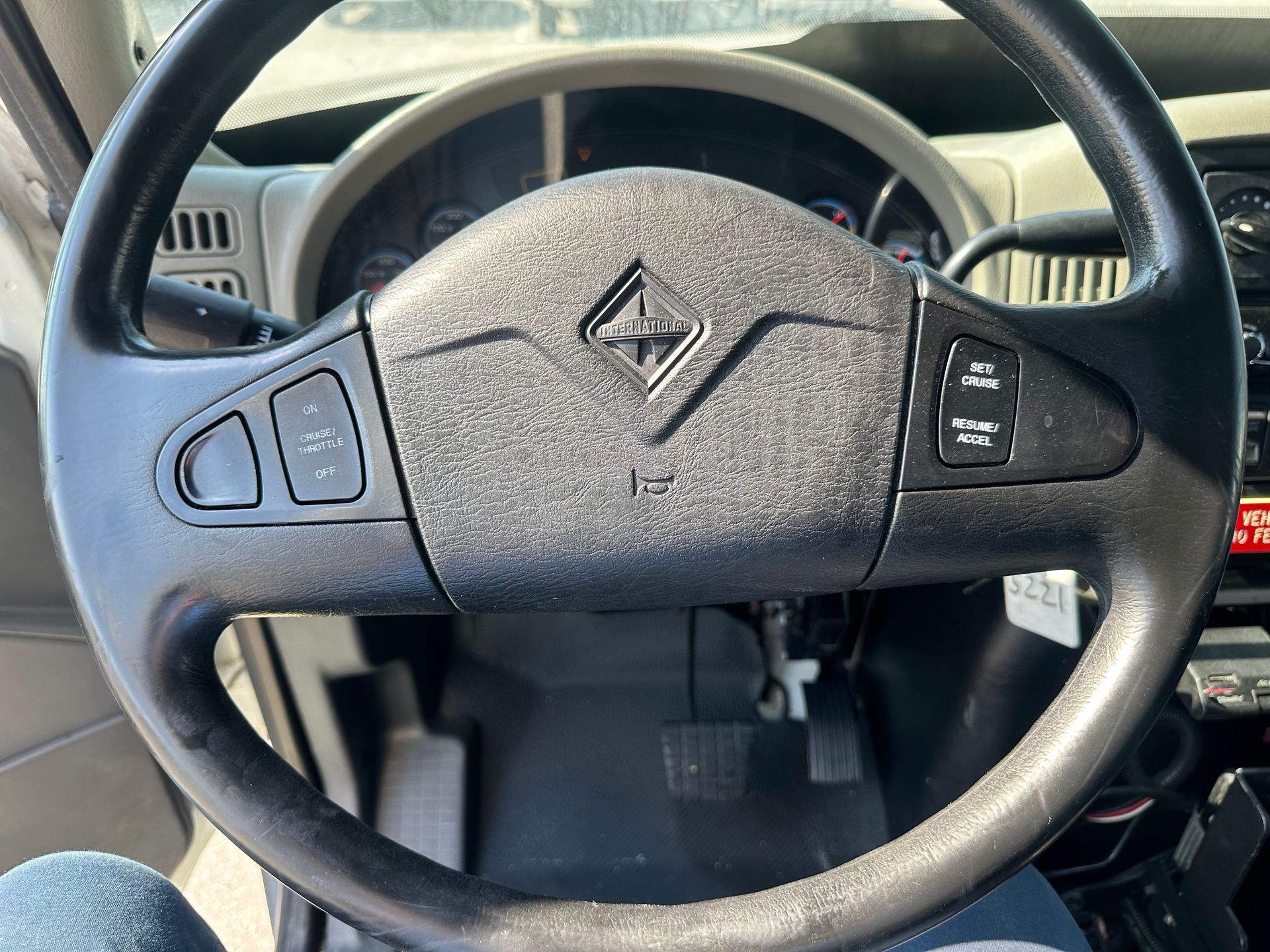 A close up of a steering wheel in a car