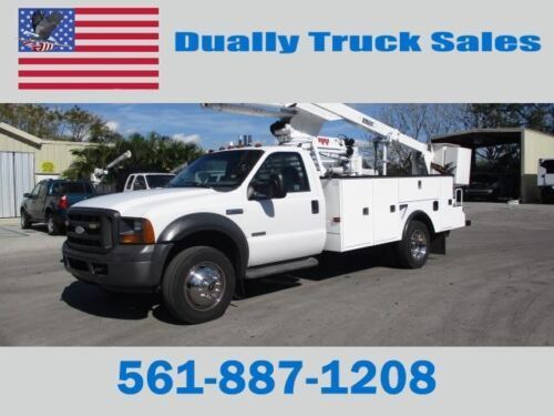 A white truck with a crane on the back is for sale by dually truck sales
