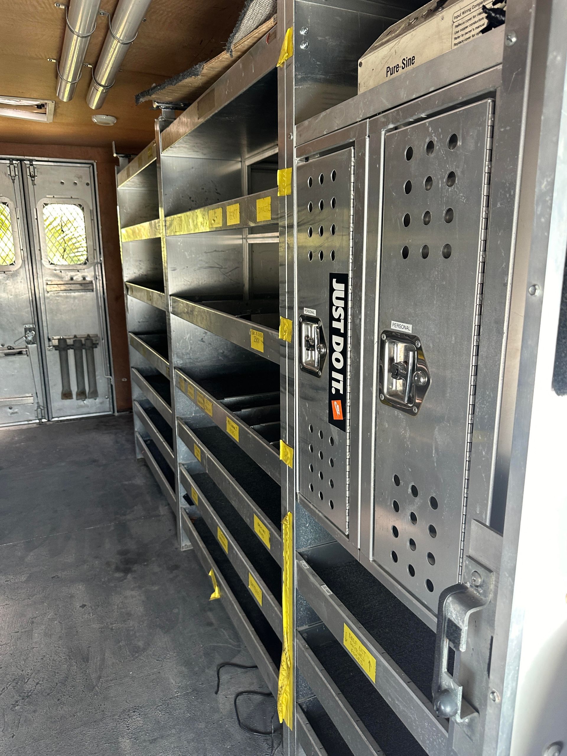 The inside of a van with shelves and a sign that says skydock