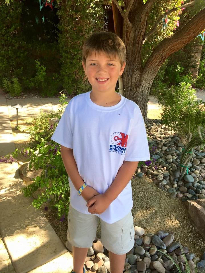 Child smiling with C & M Company shirt