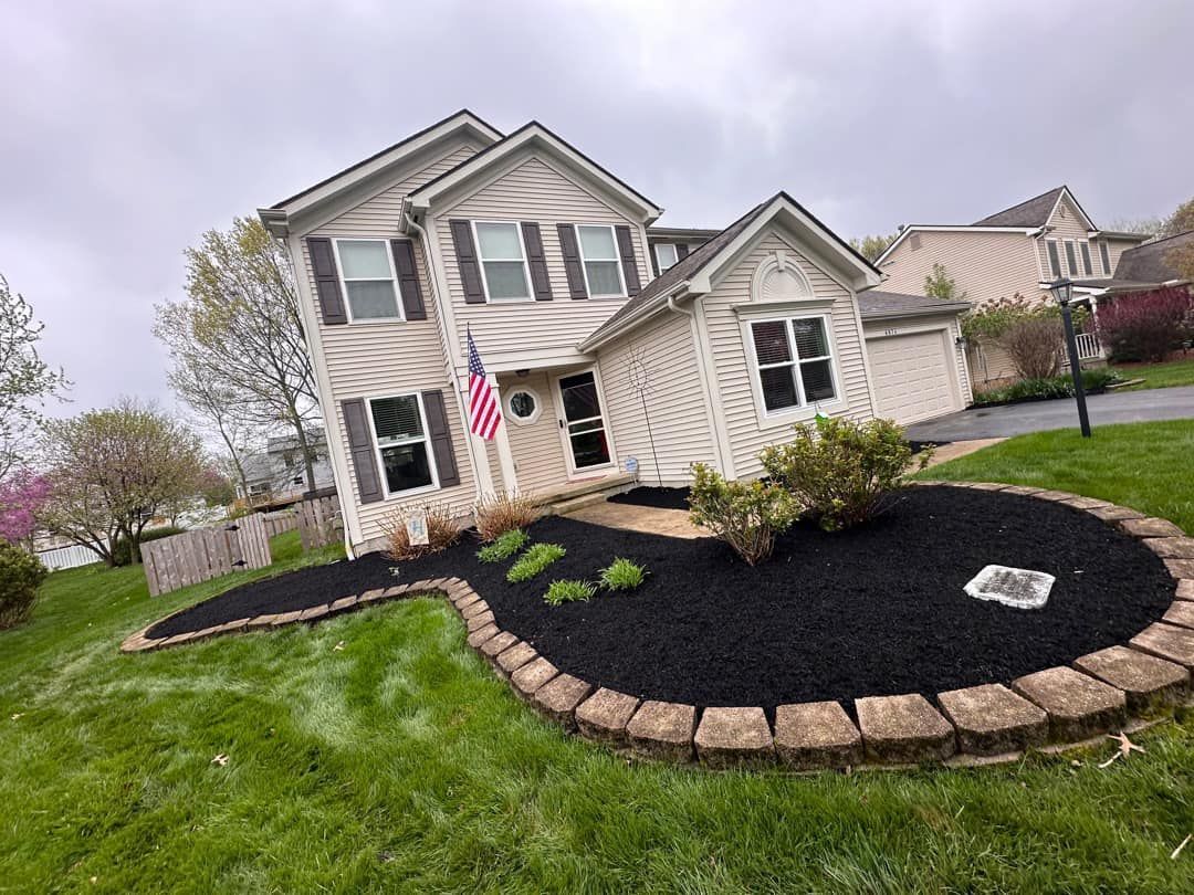 A large white house with a lush green lawn in front of it.