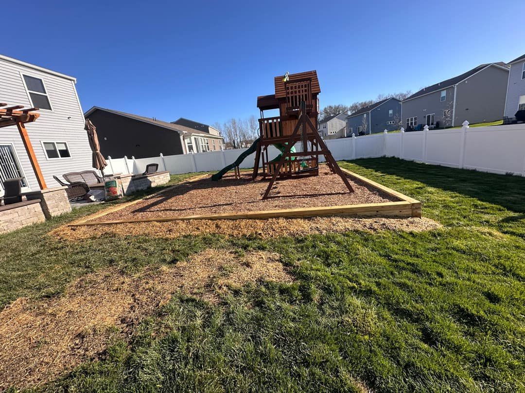 There is a playground in the backyard of a house.